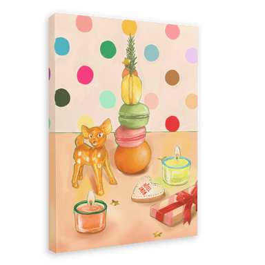 The Hôtel Dodo Merry Macaron Giclée Canvas Print features a polka dot background and showcases a vintage ornament deer figurine, a stack of macarons with fruit, candles, a heart-shaped cookie, and a gift box on a curated table setting.