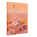 Giclée canvas print of a beach scene titled "Hôtel Dodo Uva Luva" featuring a bottle labeled "Viva" and two cocktail glasses on a striped surface, with pink sunglasses in the foreground and the ocean glowing under a beautiful sunset in the background, by Hôtel Dodo.