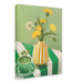 The Matcha Mornings Giclée Canvas Print by Hôtel Dodo portrays a green tea cup, a teabag, and a vase with yellow dandelions on a green and white striped tablecloth, evoking serene mornings.