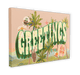 Discover the **Vintage Greetings Matte Canvas Print** by **Hôtel Dodo**, showcasing a vibrant design that prominently features the word "GREETINGS" with palm trees and various stickers, evoking nostalgic home decor.