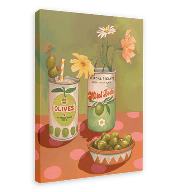 The Hôtel Dodo Olives Olé Canvas Print showcases a framed painting with two cans, one labeled "Olives" adorned with a straw and flower, the other labeled "Gordal Picante" holding flowers, accompanied by a bowl of olives on a polka dot surface that evokes Hôtel Dodo's cocktail garnish aesthetics.