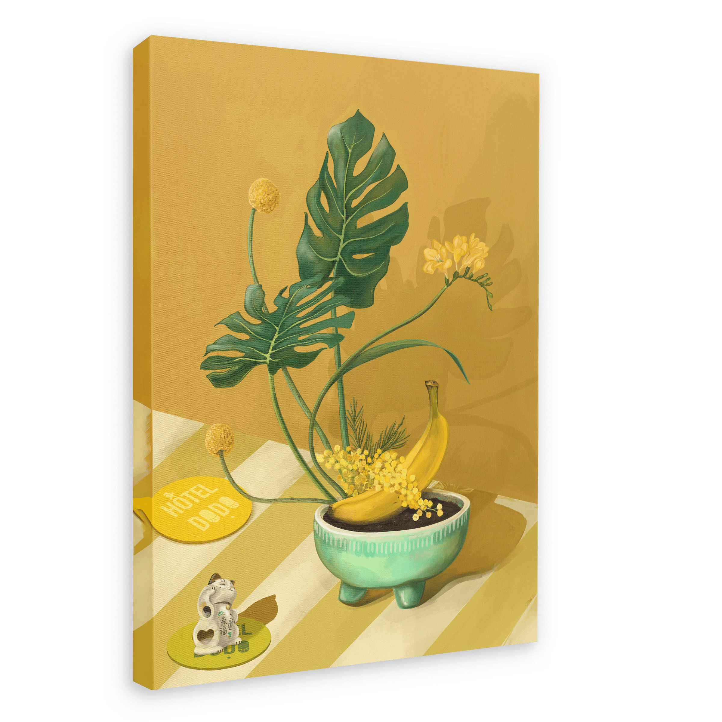 The Ikebana Banana Giclée Canvas Print by Hôtel Dodo showcases tropical foliage, yellow flowers, bananas in a bowl, a figurine, and a key tag labeled "Hôtel Dodo," all arranged on a striped surface set against a mustard-yellow background.