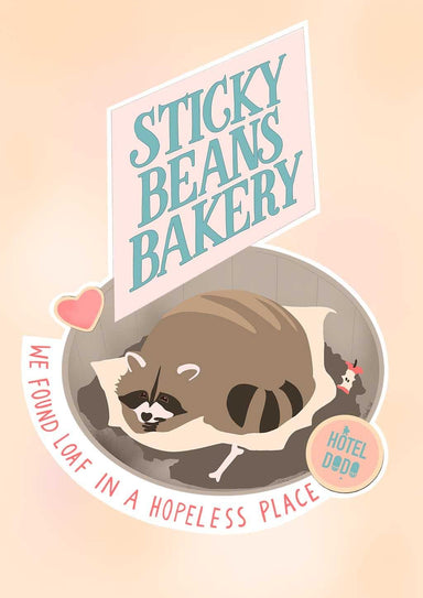 A cozy raccoon curls up like a loaf beneath a "Sticky Beans Bakery" sign. The matte art print by International Pestsellers features the text "We found loaf in a hopeless place" with a small dish labeled "Hotel Dad.