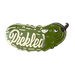 A tiny cucumber-shaped cartoon pickle pin by Pins by diedododa, featuring the word "Pickled" and an expression with raised eyebrows.