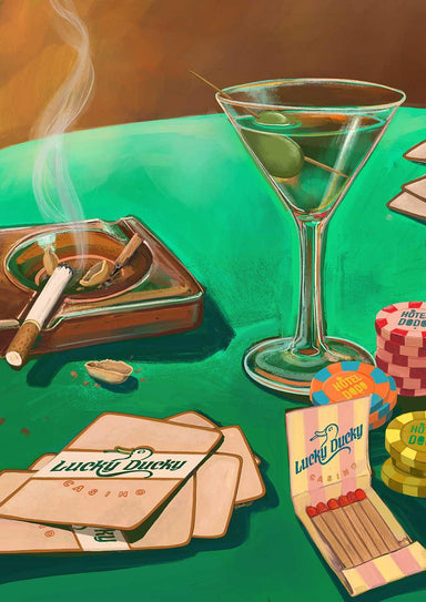 The Lucky Ducky Casino Giclée Art Print by Hôtel Dodo features a green casino table with poker chips, playing cards, a martini glass with an olive, a smoldering cigarette in an ashtray, and an open matchbook.